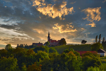 Picturesque church with wineyards in Prlekija, eastern wine region of Slovenia. Sunset above hill near Jeruzalem, Svetinje, Ljutomer