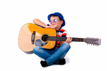 A boy kid holding guitar on a white studio background
