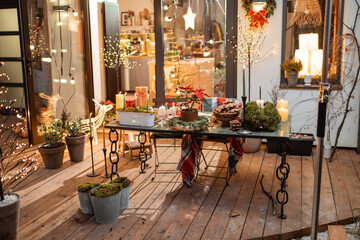 Beautifully decorated backyard of a country house with a festive dinner table during the New Year holidays