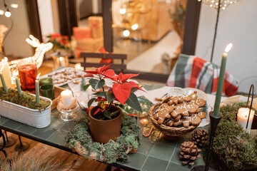 Beautifully decorated dinner table on the terrace outdoors during the New Year holidays