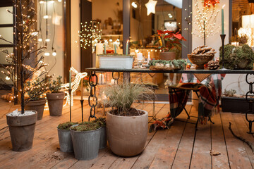 Beautifully decorated backyard of a country house with a festive dinner table during the New Year holidays