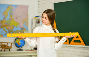 mired in geometry. School girl hold ruler. Instrument of Measurement. different school elements....