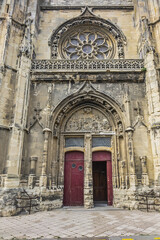 Fototapeta premium Built in heart of Fecamp XVI century Saint-Etienne church dominates now wearing Norman city: Renaissance portal, flamboyant Gothic steeple. Fecamp, Seine-Maritime department, Haute-Normandie, France.