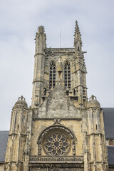 Fototapeta premium Built in heart of Fecamp XVI century Saint-Etienne church dominates now wearing Norman city: Renaissance portal, flamboyant Gothic steeple. Fecamp, Seine-Maritime department, Haute-Normandie, France.