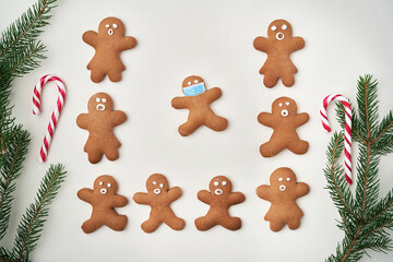 Top view of gingerbread man and one with face masks