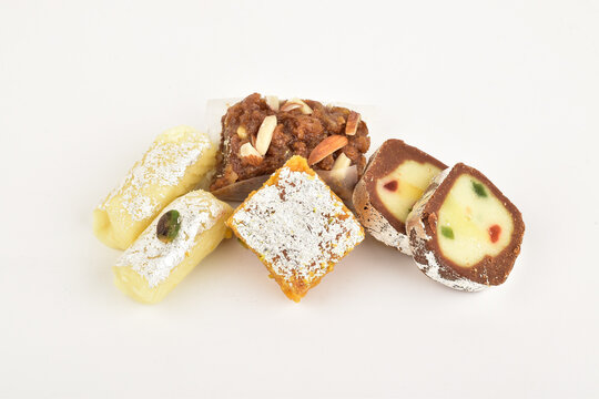 mix mithai isolated on white background, kaju anjeer barafi with pista roll