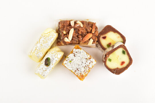mix mithai isolated on white background, kaju anjeer barafi with pista roll