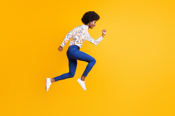 Fototapeta na wymiar Full size profile side photo of brunette lady wear blue pants white print shirt jump run sale isolated on yellow color background