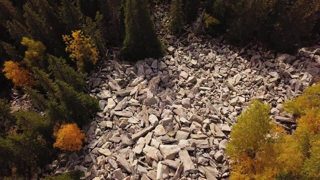 Aerial View of Stone Run at Hill Slope. Loose Rocks among Colorful Autumn Forest on Mountain captured with Drone, Zuratkul National Park