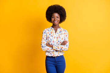 Photo of charming adorable dark skin woman wear casual outfit spectacles arms crossed isolated yellow color background
