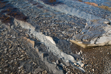 the coast of the black sea. Shallow water, water and stones.
