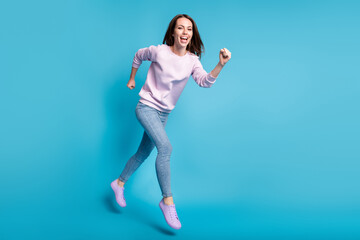 Full size photo of energetic enthusiastic girl enjoy autumn season discount jump run fast wear violet pullover gumshoes isolated over blue color background