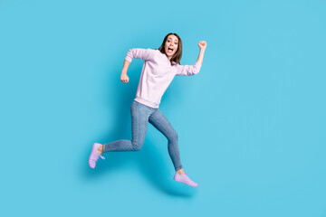 Fototapeta na wymiar Full length profile side photo of cheerful excited carefree girl jump run hurry season incredible discounts wear lilac violet pullover sneakers isolated over blue color background