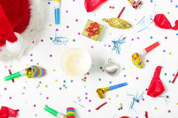 Christmas and New Year decorations with confetti, gift boxes, Santa Claus hat and party blowouts....