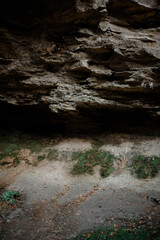 Ancient cave in a rock formed by the passing  water that  does not flow there anymore