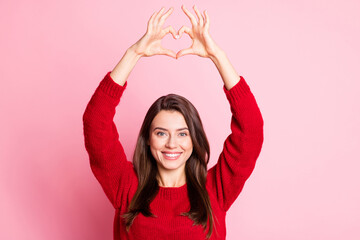 Obraz na płótnie Canvas Photo of young lovely girl raise arms show heart shape toothy smile wear red pullover isolated pink color background