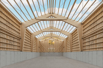 Interior of a large agricultural wooden hall during construction with an open roof