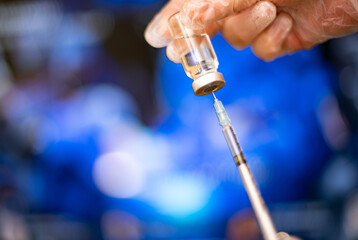 Close-up of a syringe in a vial with a vaccine.