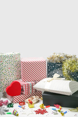 Various gift boxes on the table with Christmas ornaments. Winter's holiday celebration and gifting concept. 
