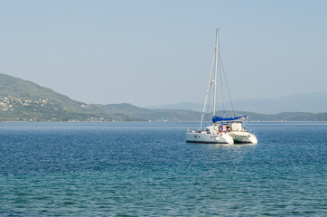 Evia island, Greece - July 01. 2020: Anchored sailboat on the island of Edipsos.