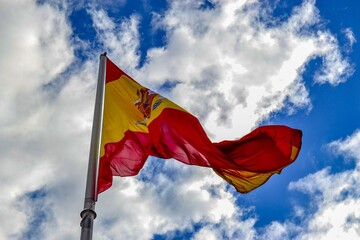 Spain, Madrid, 16.02.2012. Huge Spanish flag and huge cloudy and overcast sky background in madrid during winter.
