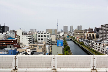 Bus ride from Narita international airport into Tokyo. River and skyline with skytree television tower. Urban landscape of Tokyo, Japan. April 2015.