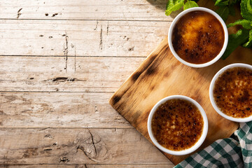 Homemade creme brulee in bowl on wooden table.Top view.Copy space