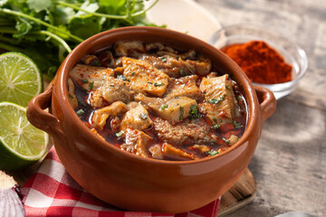 Traditional mondongo or el menudo soup on wooden table