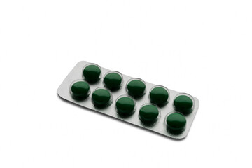 Aluminum foil-covered blister pack with green tablets, isolated on a white background