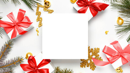 Christmas composition. White gift box with red ribbon, New Year balls and Christmas tree in xmas composition on white background for greeting card. Flat lay, top view, copy space.