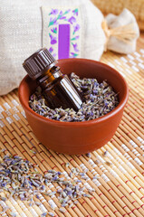 Small bottle with essential lavender oil (extract, tincture, infusion, perfume). Aromatherapy, spa and herbal medicine ingredients.