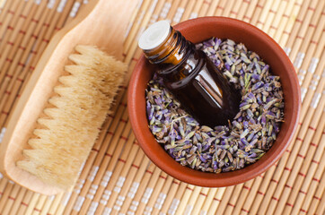 Small bottle with essential lavender oil (extract, tincture, infusion, perfume). Aromatherapy, spa and herbal medicine ingredients.