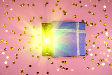 Opening gift blue box with magical special effects lights and golben sparkles