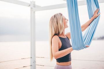 Beautiful woman doing yoga near by the sea.