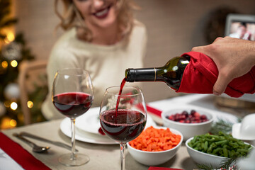 Close up of pouring red wine during Christmas dinner