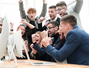 excited business team is jubilant in the workplace.