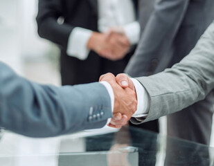 business partners shaking hands in the business center office