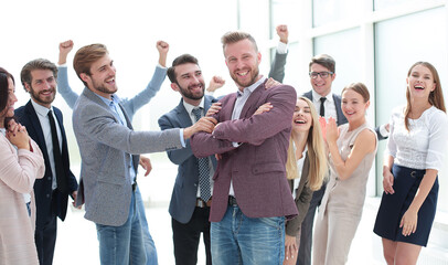 creative team congratulating their leader. success concept