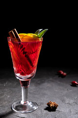 Creative holiday beverage cocktail in geometry drinking glass oh black background