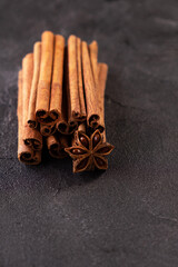Cinnamon stick and star anise spice on black background