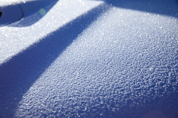 Icy texture on car hood in winter