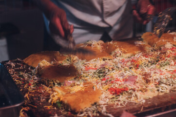 Man cooking Okonomiyaki at food stall at festival(Matsuri) in Japan / Small business