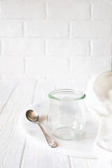 Fototapeta na wymiar Empty glass jar on rustic wooden table over white background