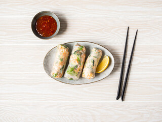 Vietnamese spring rolls and spicy sauce in bowl