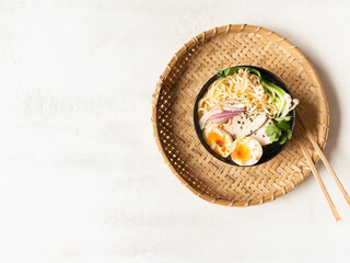 Chicken ramen noodle soup with meat, bok choy, mushrooms, egg