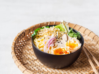 Chicken ramen noodle soup with meat, bok choy, mushrooms, egg