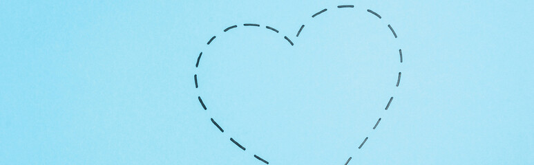 top view of dotted line heart on blue background, 