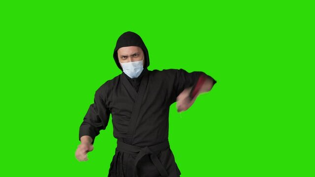 Video of man in black costume ninja with nunchucks