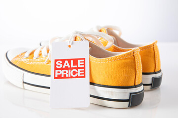  yellow shoes with red label sale on white background