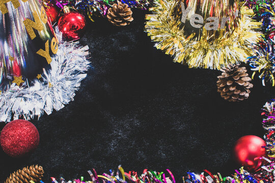 Happy new year celebration concept decorated with hat,balls,dried pine cones and black copy space at center